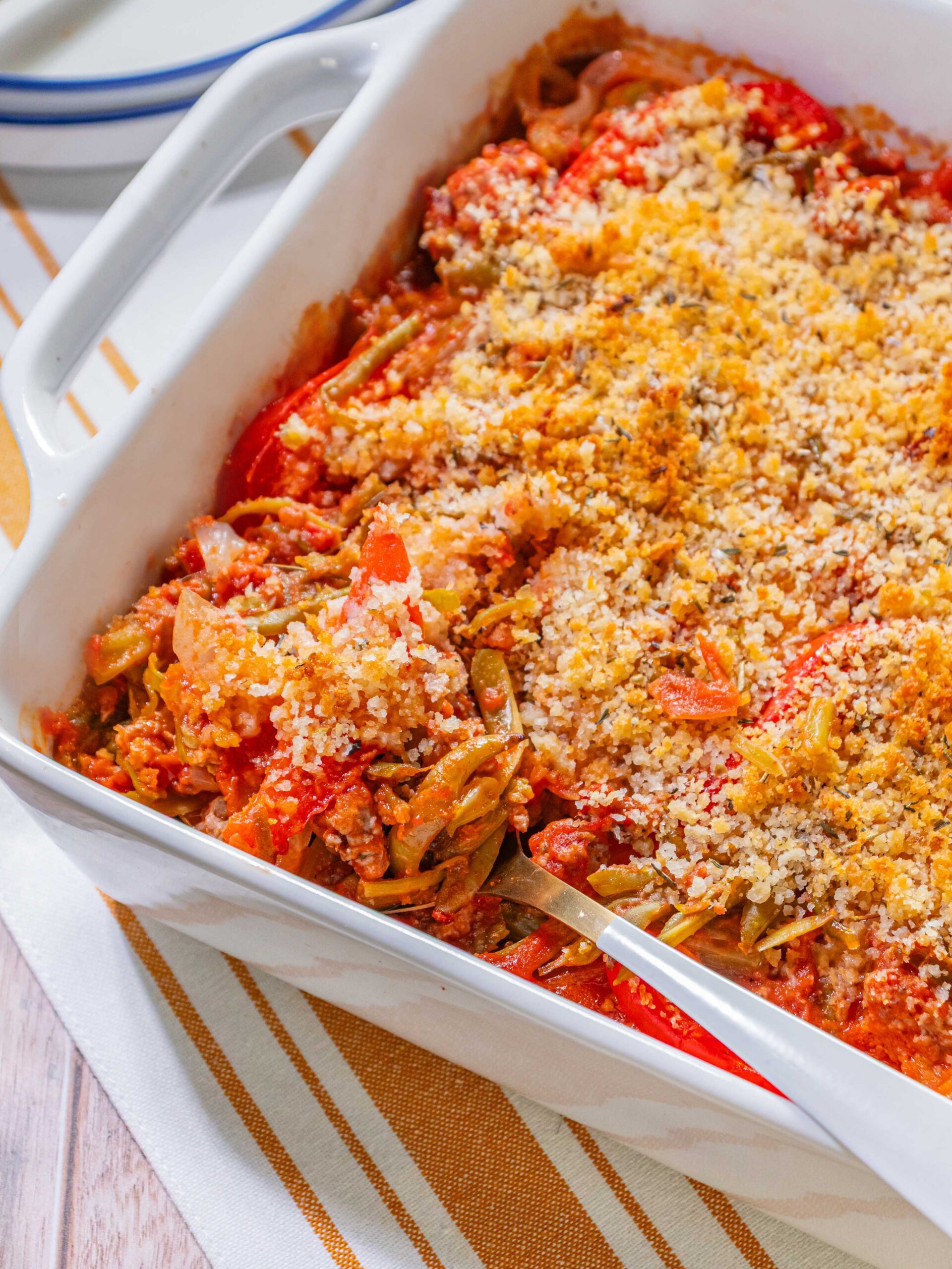 Italian twist on a green bean casserole, add sausage, bell peppers, canned french style green beans, and a creamy tomato sauce